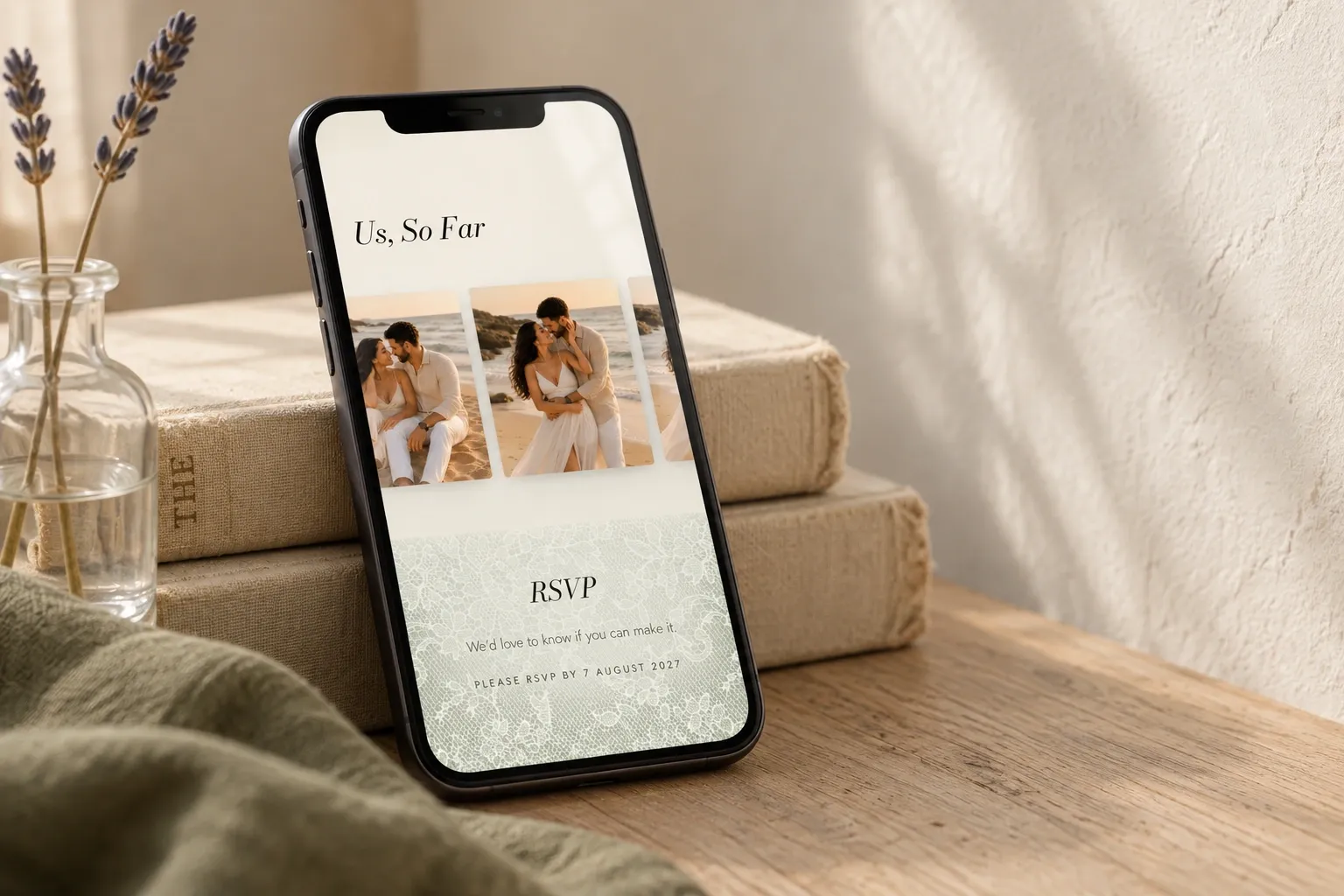 Olive and Ivory photo gallery and lace RSVP section on a tilted phone leaning against ivory books